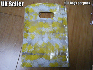 100 x CLEAR PLASTIC YELLOW SWIRLS GIFT PARTY CARRIER BAGS SHOPS SWEETS 18cmx12cm