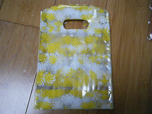 Load image into Gallery viewer, 100 x CLEAR PLASTIC YELLOW SWIRLS GIFT PARTY CARRIER BAGS SHOPS SWEETS 18cmx12cm
